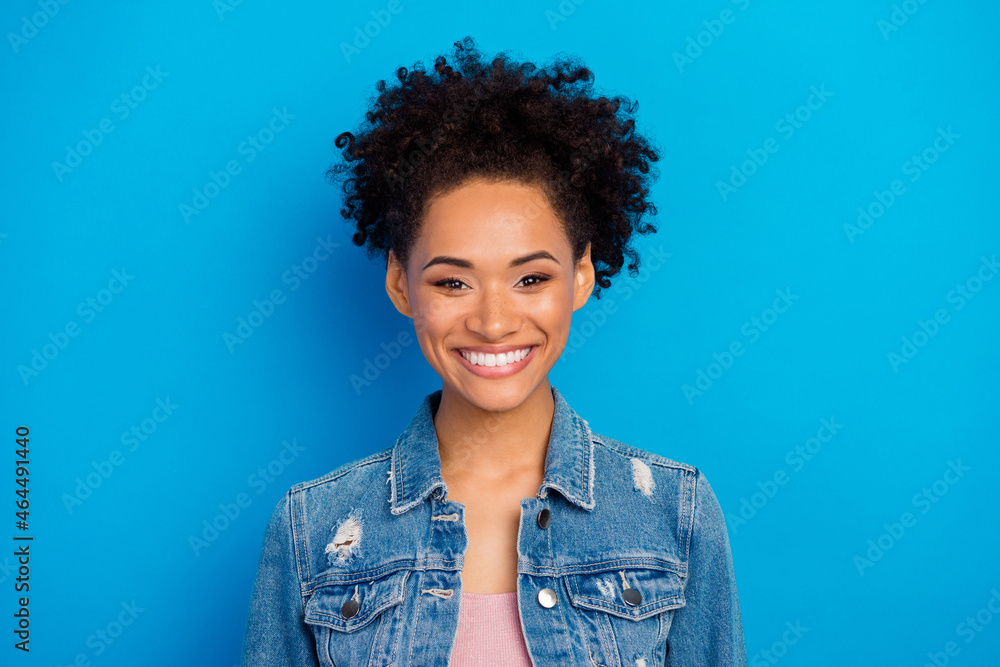 Photo of young happy cheerful woman wear casual denim jacket isolated on blue color background Photo of young happy cheerful woman wear casual denim jacket isolated on blue color background