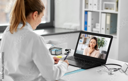 healthcare, technology and medicine concept - female doctor having video call with sick woman patient on laptop computer at hospital © Syda Productions