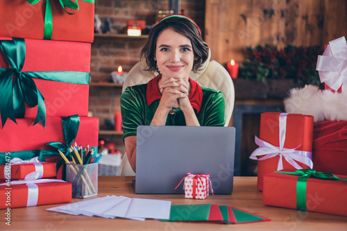 Photo of young woman elf santa helper christmas sit desk laptop workplace good mood indoors inside house home