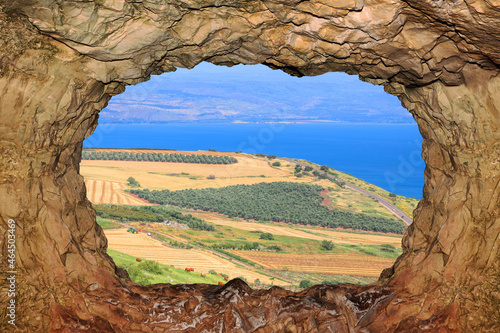 Agricultural valley Arbel and Kinneret or Sea of Galilee or Tiberius lake view through a rocky window. Israel