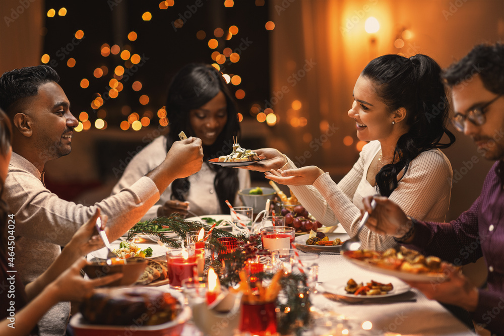 © Syda Productions - holidays, party and celebration concept - multiethnic group of happy friends having christmas dinner at home © Syda Productions - holidays, party and celebration concept - multiethnic group of happy friends having christmas dinner at home