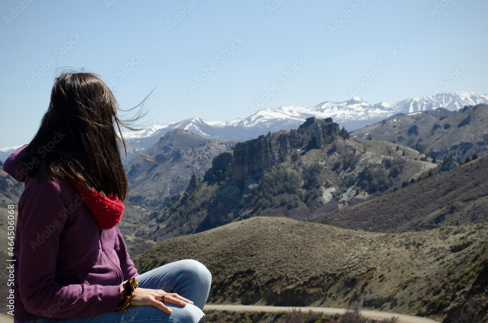 woman from behind, looking at the landscape of the Andes mountain range