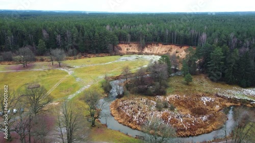 Fly over a winding river and green forest