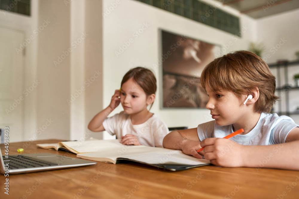 Teen children study online on computer at home Teen children study online on computer at home