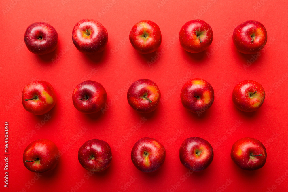 Many red apples on colored background, top view. Autumn pattern with fresh apple above view Many red apples on colored background, top view. Autumn pattern with fresh apple above view