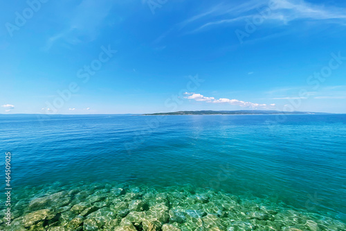 Summer vacation concept. Blue transparent sea water texture. Background of tranquil ocean water. Sea landscape with clear water.