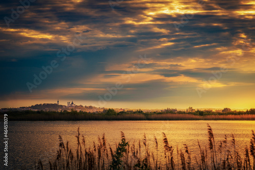 basilica in Chełm on a cloudy morning by the lake 