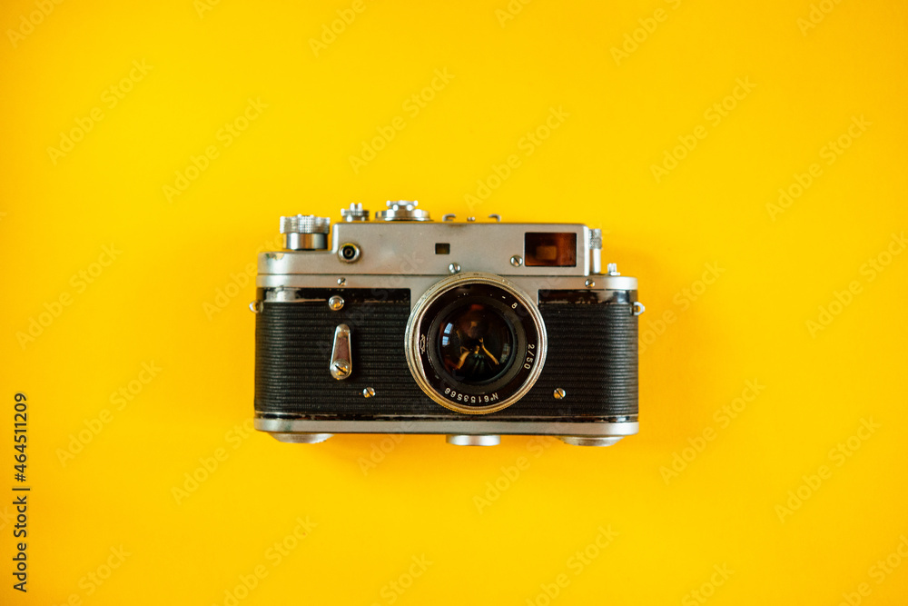 Fototapeta premium Vintage Photo Camera on yellow background