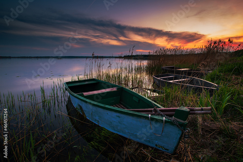sunset on the lake and boat in wytyckie lake, poland lubelskie