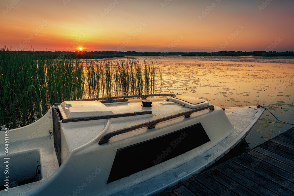 sunset on the lake and boat in wytyckie lake, poland lubelskie sunset on the lake and boat in wytyckie lake, poland lubelskie