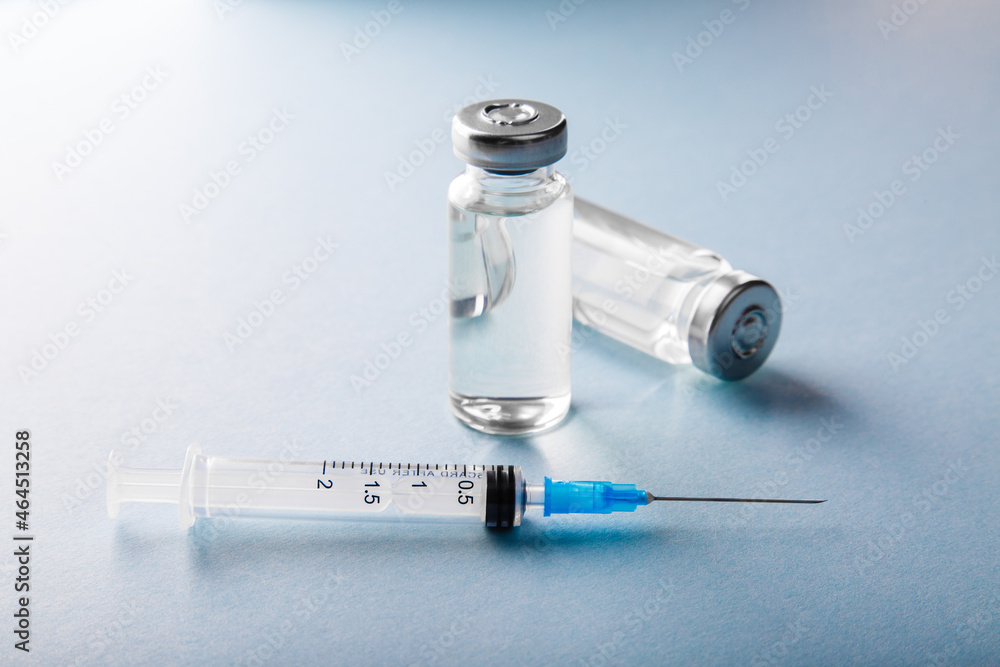 Syringe and vaccine vial on blue background. Treatment for coronavirus covid-19. Safety at pandemic or quarantine. Stay safe. Preparation for injection or virus. Preventive medicine Syringe and vaccine vial on blue background. Treatment for coronavirus covid-19. Safety at pandemic or quarantine. Stay safe. Preparation for injection or virus. Preventive medicine