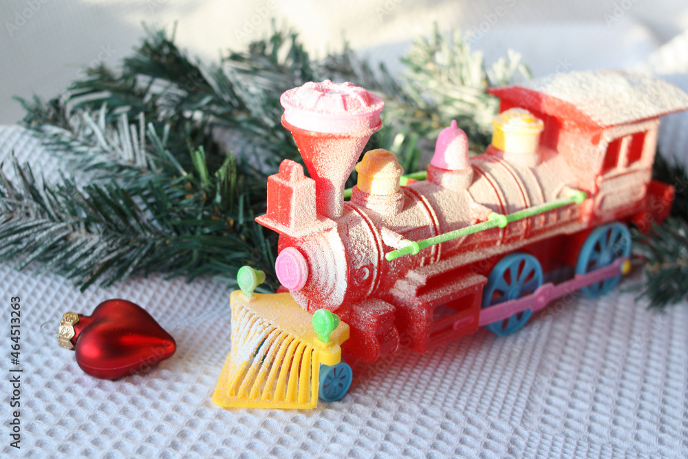 Red train in the snow. Copy space below on white background for your welcome text. Christmas, New Year card concept. Selective focus.