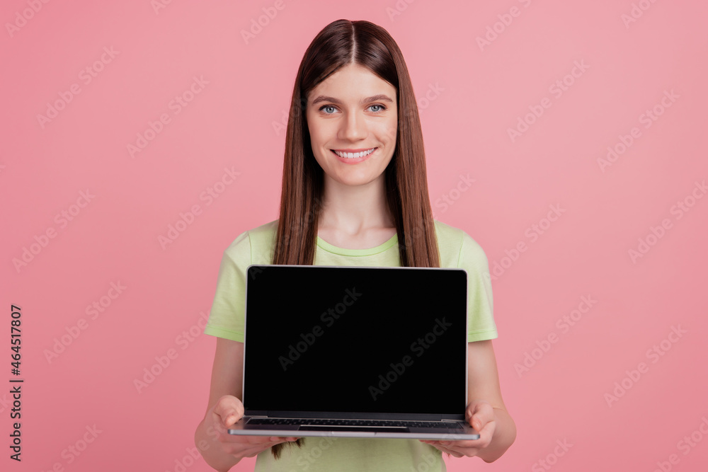 Naklejka premium Photo of young cheerful girl hold laptop pc computer with blank empty screen advert advice isolated over pink color background