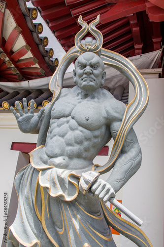the Nio statue,  one of two wrathful and muscular guardians of the Buddha standing at the entrance of Buddha Tooth Relic Temple in Singapore Chinatown,  in the form of frightening wrestler-like statue photo