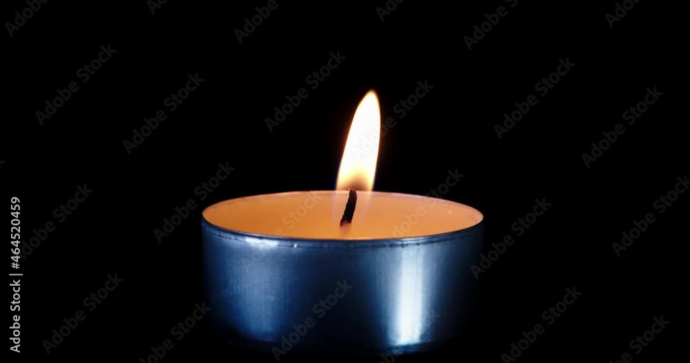 Candle on a black background. The flame of the candle slowly flickers. One candle slowly flickers. Ideal for background or over-layer with blending mode add, screen, lighten. Candle on a black background. The flame of the candle slowly flickers. One candle slowly flickers. Ideal for background or over-layer with blending mode add, screen, lighten.