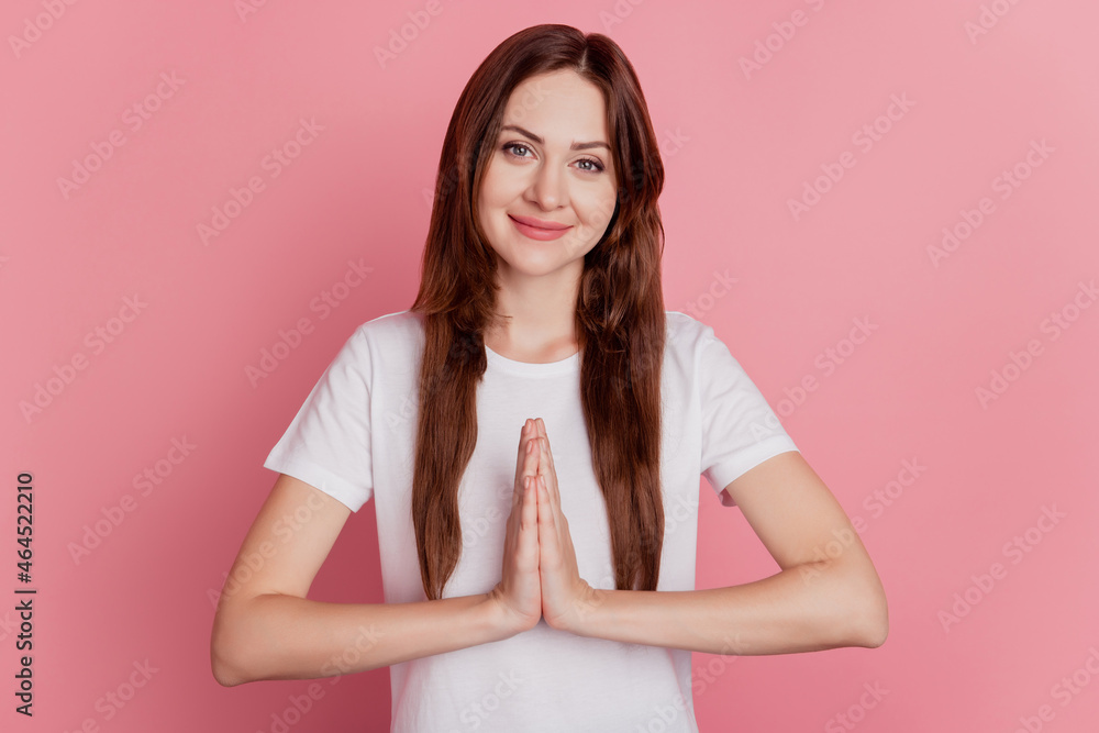 Portrait of cute positive dreamy girl hold hands plead ask help on pink background Portrait of cute positive dreamy girl hold hands plead ask help on pink background