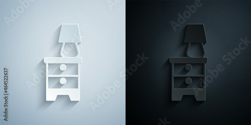 Paper cut Furniture nightstand with lamp icon isolated on grey and black background. Paper art style. Vector