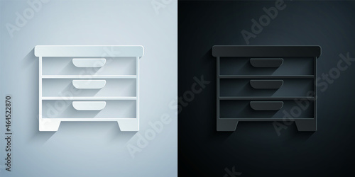 Paper cut Chest of drawers icon isolated on grey and black background. Paper art style. Vector