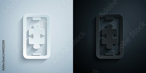 Paper cut Smartphone and playing in game icon isolated on grey and black background. Mobile gaming concept. Paper art style. Vector
