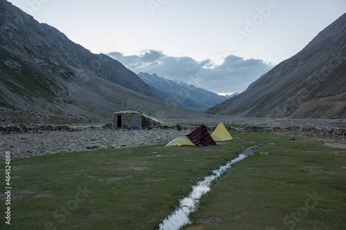 Tents pitched on a beautiful campsite on a meadow on a trekking route in the Himalayan valley of Zanskar. photo