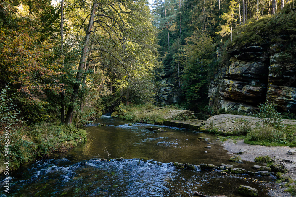 Bohemian Switzerland National Park, Czech Republic, 2 October 2021:  Ruins of Dolsky mlyn at River Kamenice, old stone water mill at Ceske Svycarsko, autumn sunny day, abandoned building, old masonry