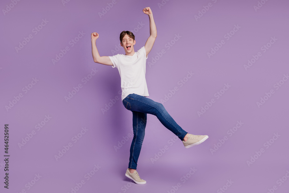 Fototapeta premium Full length photo of young cheerful positive man rejoice victory fists hands isolated on violet color background