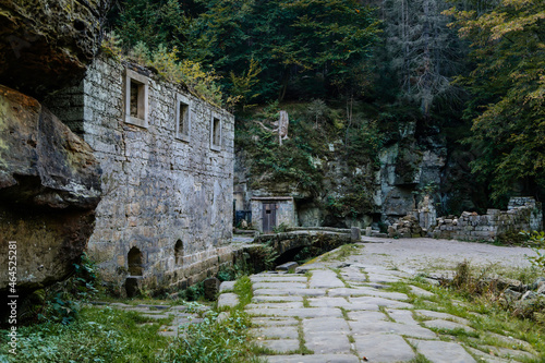 Bohemian Switzerland National Park, Czech Republic, 2 October 2021: Ruins of Dolsky mlyn at River Kamenice, old stone water mill at Ceske Svycarsko, autumn sunny day, abandoned building, old masonry