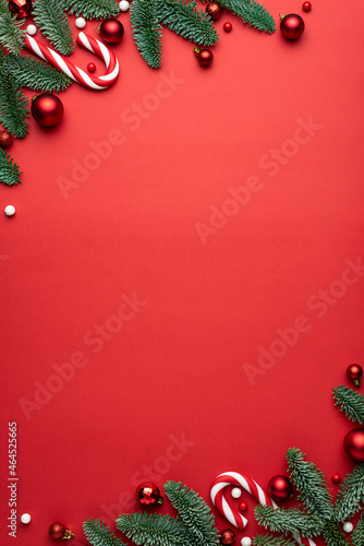 Red Christmas background with fir branches and decorations