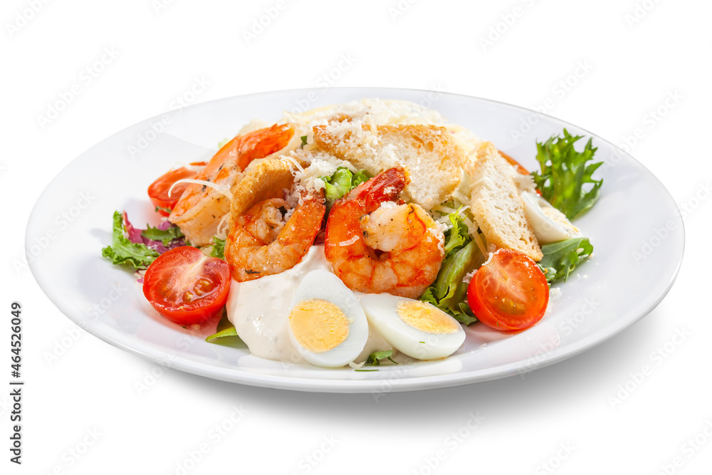 caesar salad with shrimps on a white plate, close-up, isolate caesar salad with shrimps on a white plate, close-up, isolate