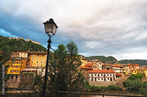 View of Italian town of Varallo Sesio in the Province of Vercelli, Piedmont, Italy, with famous pilgrimage place of Sacro Monte visible on top of the hill. photo