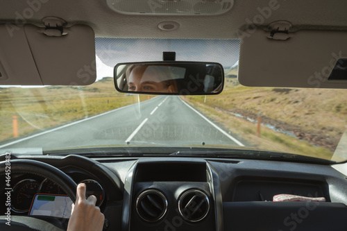 Fototapeta Naklejka Na Ścianę i Meble -  Female driver using navigation app while traveling to the destination through the Iceland