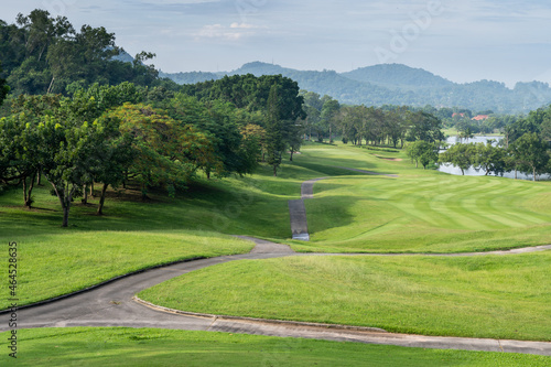 The view of the golf course fairway with mountains and ponds is very beautiful