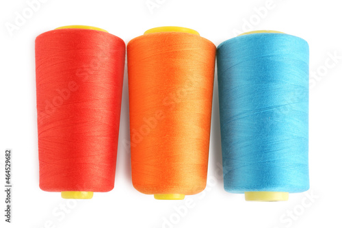 Colorful sewing threads on white background, top view