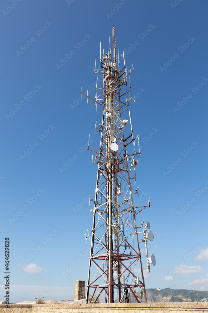 4G and 5G cell site. Base Station or Base Transceiver Station. Wireless Communication Antenna Transmitter. Telecommunication tower with antennas against blue sky.