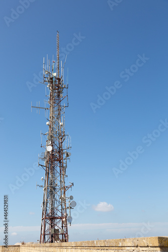 4G and 5G cell site. Base Station or Base Transceiver Station. Wireless Communication Antenna Transmitter. Telecommunication tower with antennas against blue sky.
