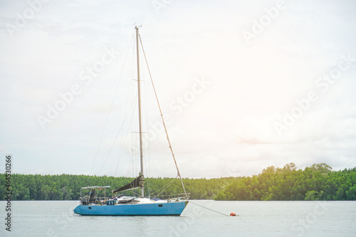 A Sailing boat in the sea against the backdrop of mountains, summer adventure