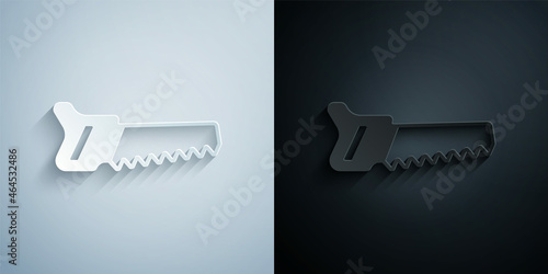 Paper cut Hand saw icon isolated on grey and black background. Paper art style. Vector