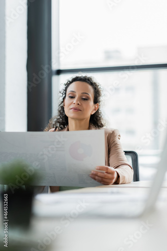 Free Download african american businesswoman working with document in office on blurred foreground - GFXLoad
