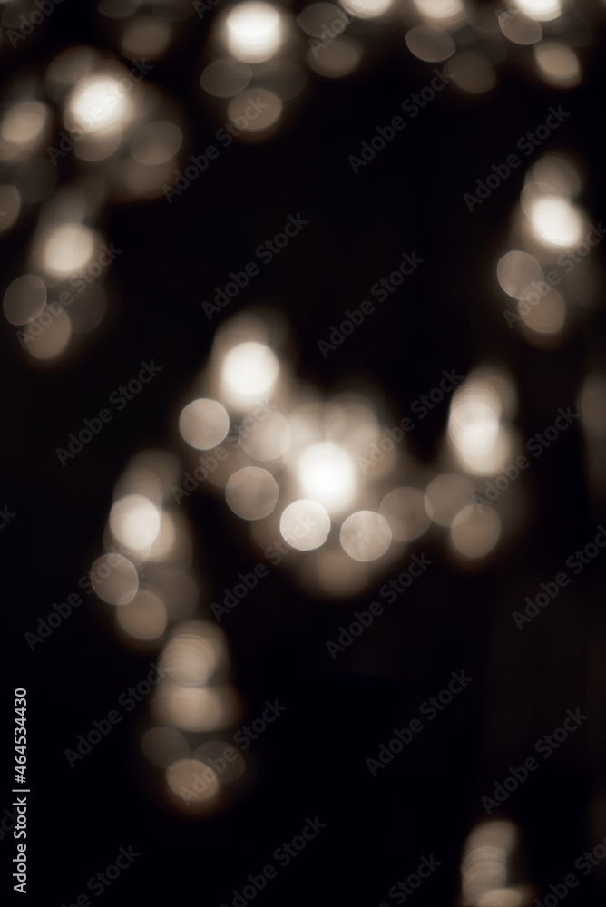 White bokeh lights in the dark. Christmas garland. 