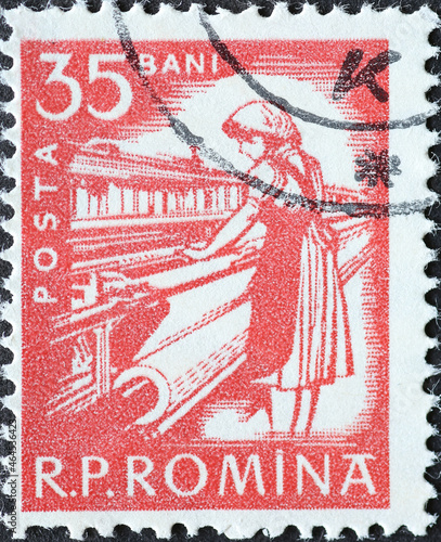 Romania - Circa 1960: a postage stamp printed in the Romania showing a female weaver at the loom