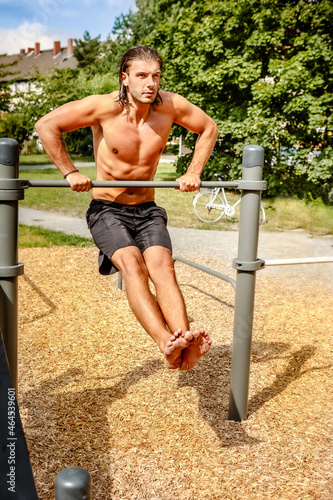 Young man exercises sports In the park, fitness concepts. © Margarita Borodina