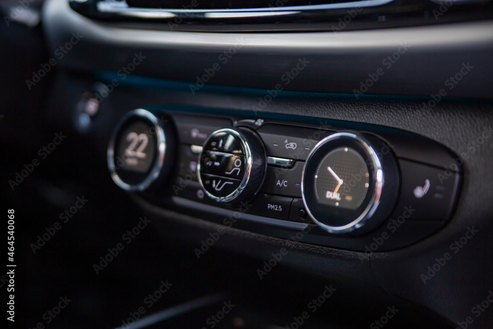 multimedia control console and climate in a modern car. close-up, selective focus, no people