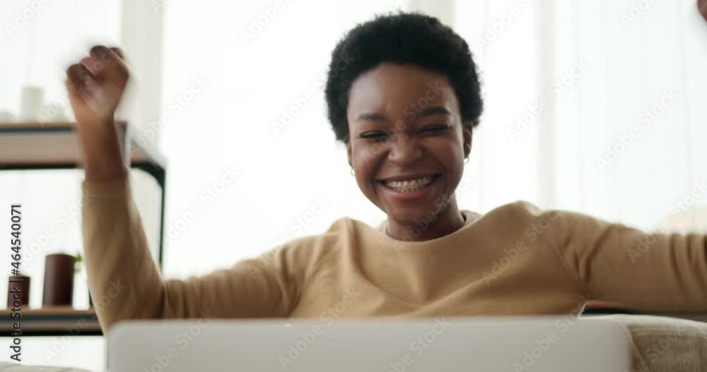 Woman with fingers crossed wishing for good luck and celebrating success using laptop at home Woman with fingers crossed wishing for good luck and celebrating success using laptop at home