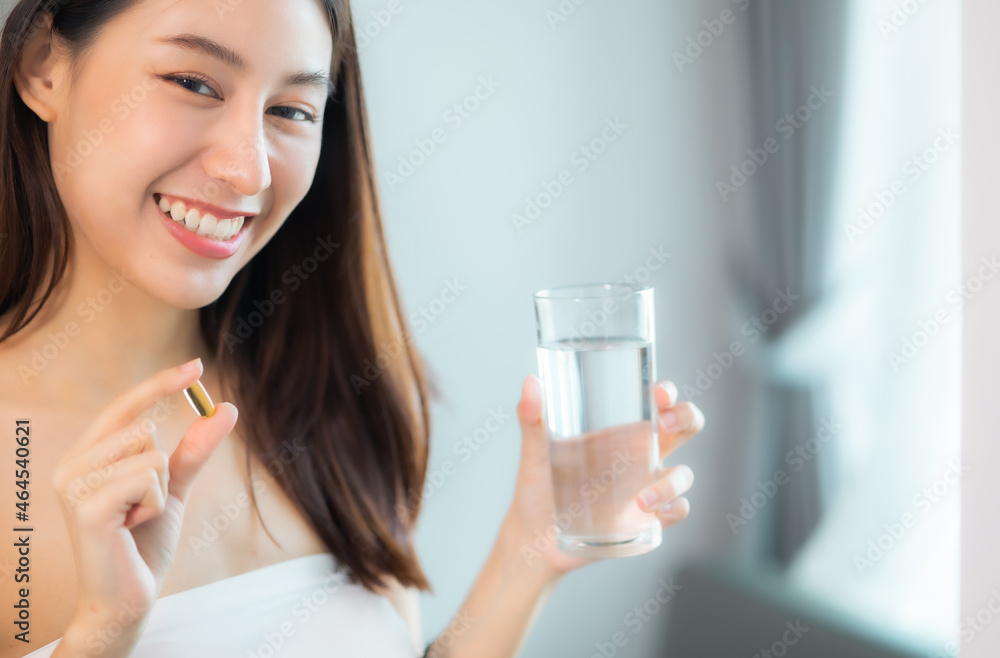 young beauty asian Pregnant woman holding vitamin pill isolated at home.healthcare and medical concept. young beauty asian Pregnant woman holding vitamin pill isolated at home.healthcare and medical concept.