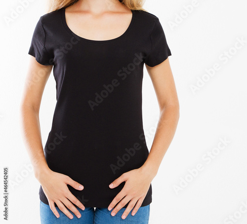 Cropped portrait of young white girl with beautiful slim body wearing black tshirt with copy space for your text or advertising content. Close up of fashionable teenager trying on new clothing