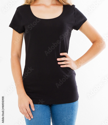 Cropped portrait of young white woman with beautiful slim body wearing black T-shirt with copy space for your text or advertising content. Close up of fashionable teenager trying on new clothing