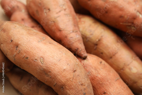 Whole ripe sweet potatoes as background, closeup