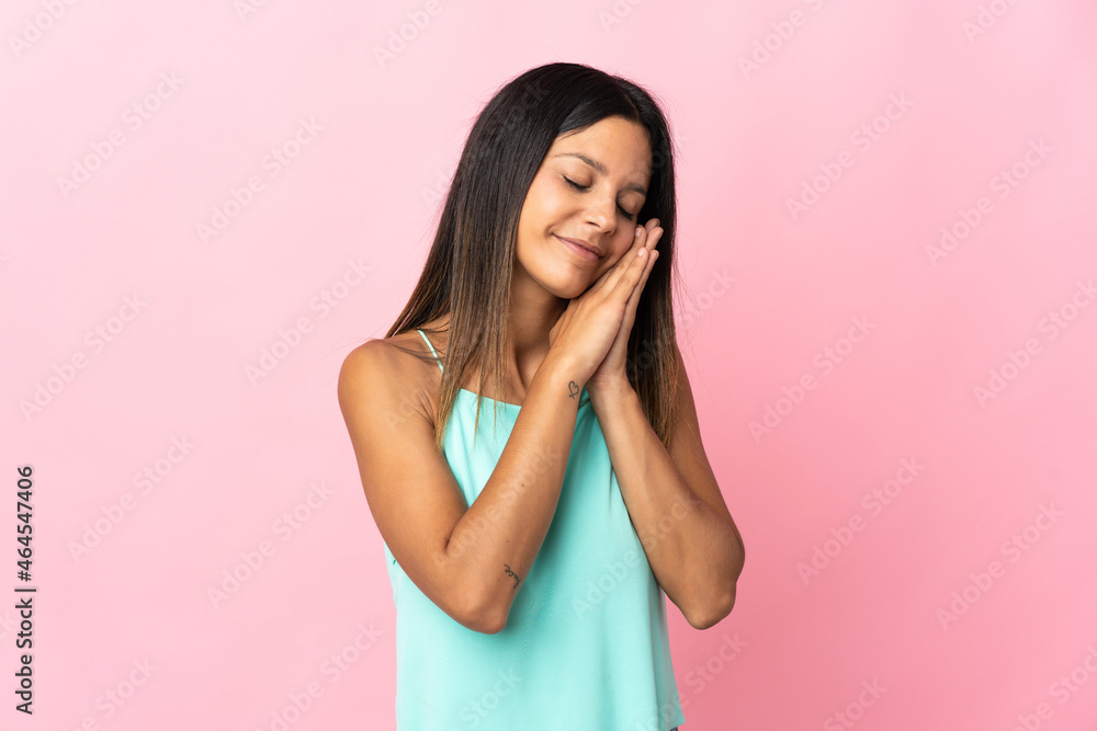 Caucasian girl isolated on pink background making sleep gesture in dorable expression Caucasian girl isolated on pink background making sleep gesture in dorable expression