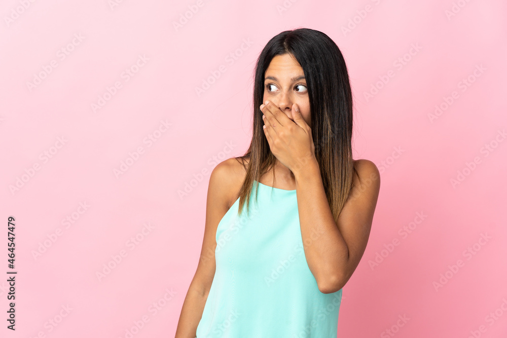 Caucasian girl isolated on pink background doing surprise gesture while looking to the side Caucasian girl isolated on pink background doing surprise gesture while looking to the side
