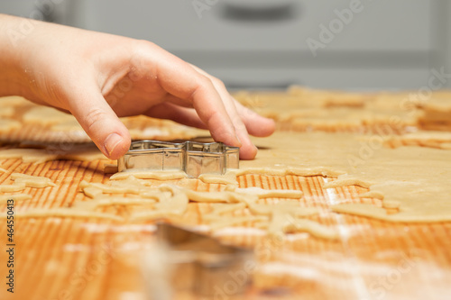 Unrecognizable woman making gingerbread in the kitchen
